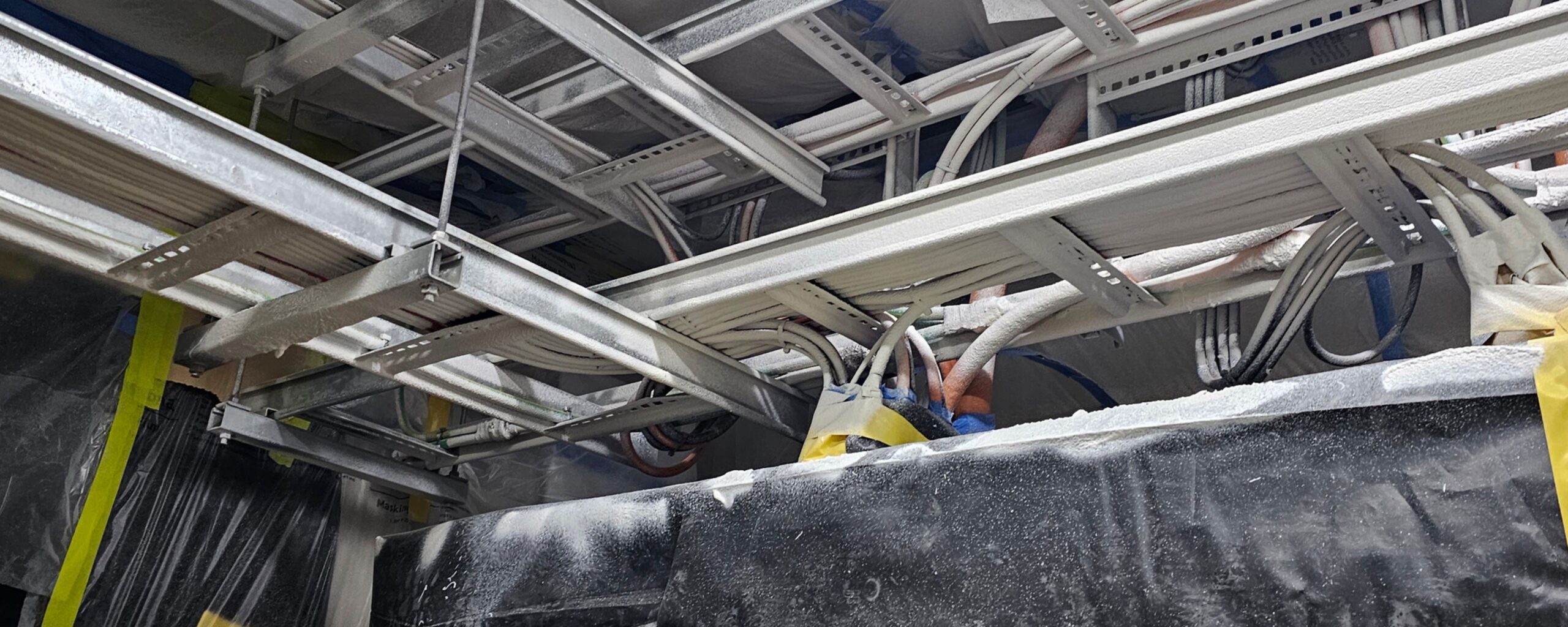 Industrial structural steel with protective coatings applied